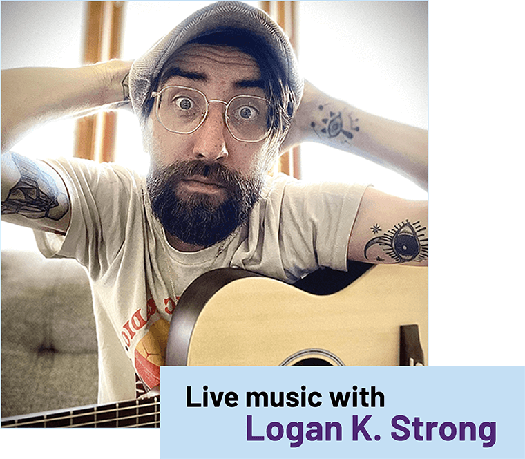 Musician Logan Strong posing with his guitat