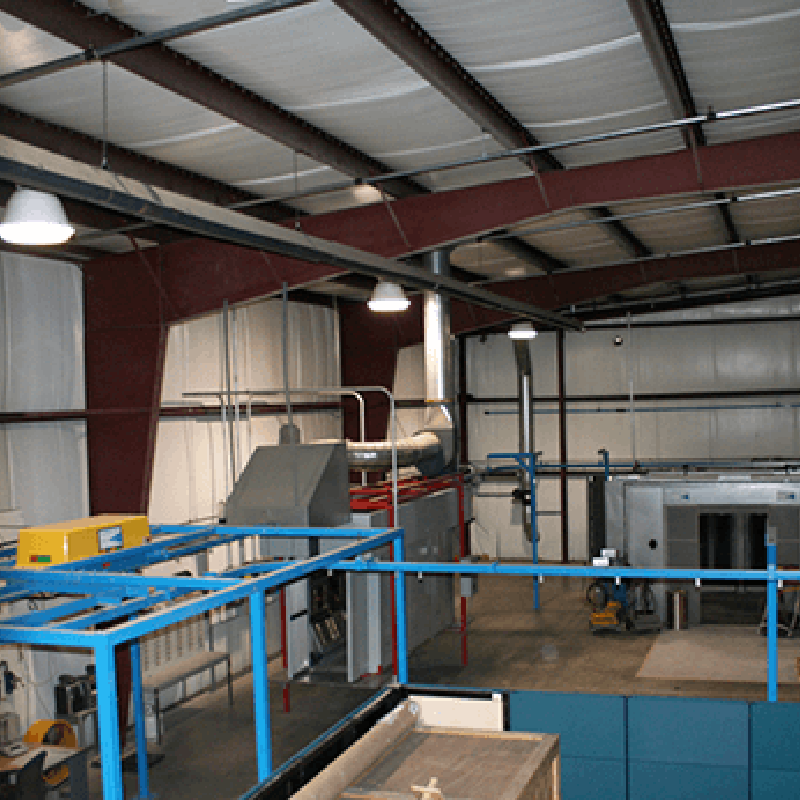 Overlook of facility showing conveyor, powder booth and cure oven