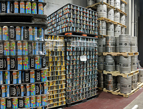 stacks of multicolored cans and stacks of large keg containers