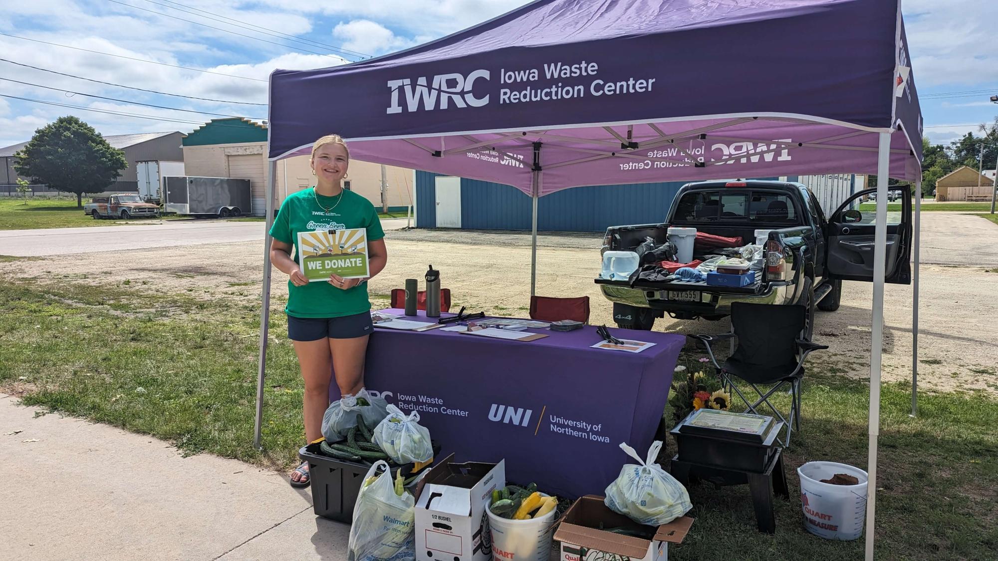 Environmental Intern, Makayla Gasper, standing with food collected at the end of the Manchester Farmers Market. 