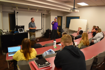 Presenters Chris Lampe and Joe Bolick present in front of Economics of Sustainability class
