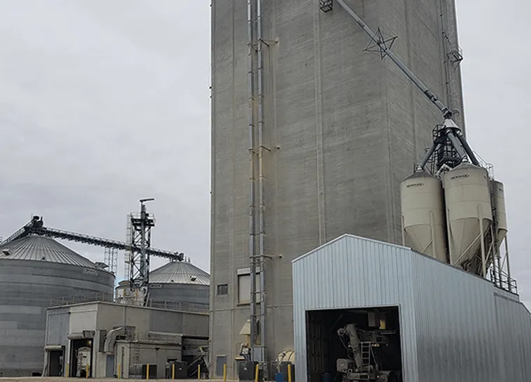 Modern Granary elevator. Silver silos on agro-processing and manufacturing plant for processing drying cleaning and storage of agricultural products.