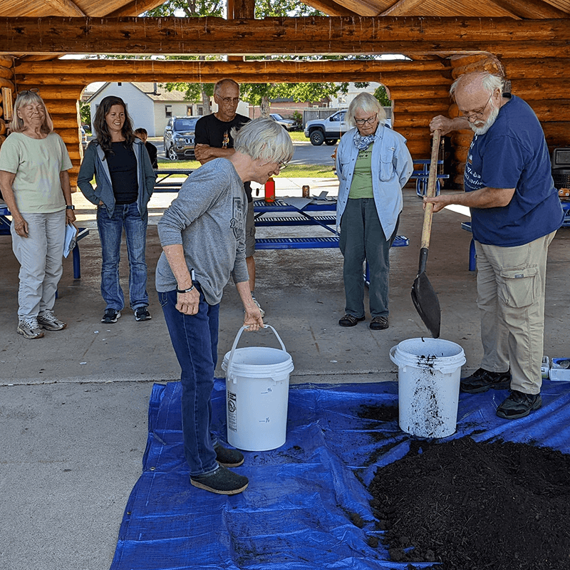 Workshop participants working with compost